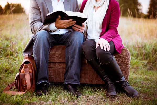 couple on luggage reading bible-ben-white